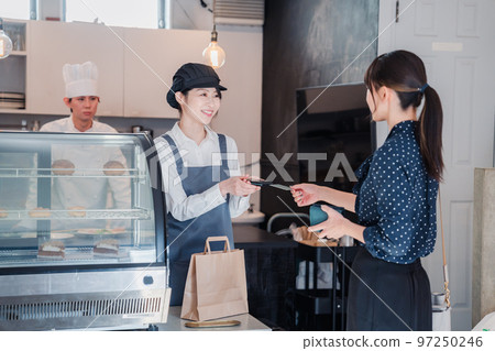 在糖果店用信用卡付款的女人 在糖果店用信用卡付款的女人 97250246