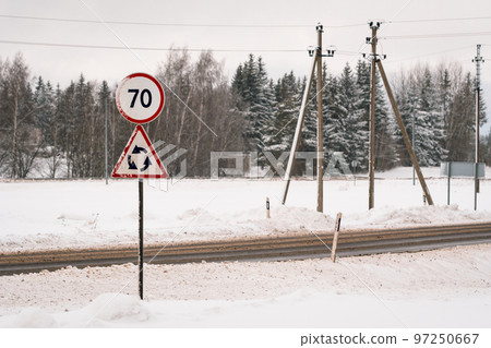 Highway with speed limit 70 road sign, roundabout ahead Highway with speed limit 70 road sign, roundabout ahead 97250667