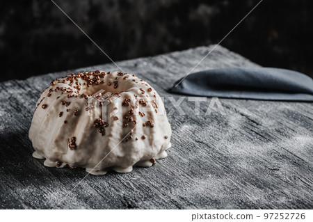 gugelhupf cake covered with a vanilla frosting 97252726