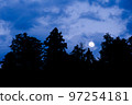Full moon rising over the forest 1 97254181