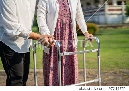 Help and care Asian senior or elderly old lady woman use walker with strong health while walking at park in happy fresh holiday. Help and care Asian senior or elderly old lady woman use walker with strong health while walking at park in happy fresh holiday. 97254751