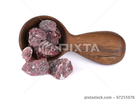 Benzoin Siam resinoid in wooden spoon, isolated on white background. Mix of benzoin and Dammar resin. Tropical resins. Top view. 97255076