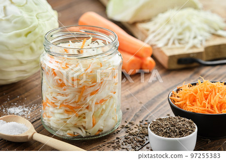 Chopped cabbage in a jar for making pickled sauerkraut. Cooking of homemade sour cabbage. Fermented product, coleslaw salad. Healthy food, diet food. 97255383