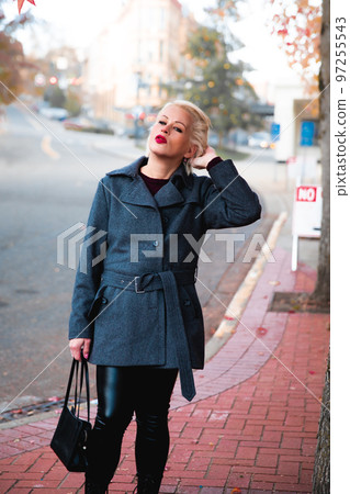 Fashionable blonde woman walking exploring the city. Fashionable blonde woman walking exploring the city. 97255543