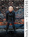 Fashionable blonde woman walking exploring the city. 97255546