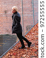 Fashionable blonde woman walking exploring the city. 97255555
