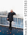 Fashionable blonde woman walking exploring the city. 97255563