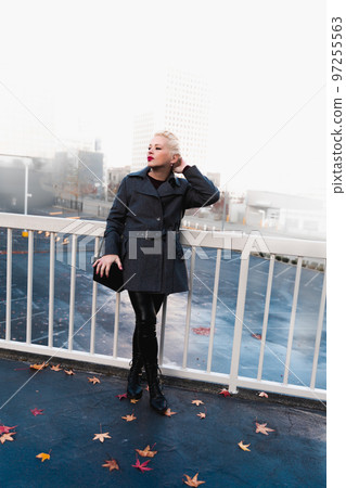 Fashionable blonde woman walking exploring the city. Fashionable blonde woman walking exploring the city. 97255563
