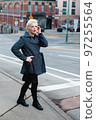 Fashionable blonde woman walking exploring the city. 97255564