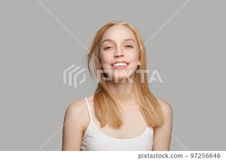 Happy smiling woman with blonde hair and natural makeup on white background Happy smiling woman with blonde hair and natural makeup on white background 97256646