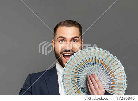 Young happy businessman with really impressive achievements screaming with happiness Young happy businessman with really impressive achievements screaming with happiness 97256846
