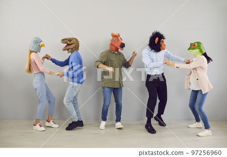 Group of strange young people in funny animal masks dancing and having fun at crazy party 97256960