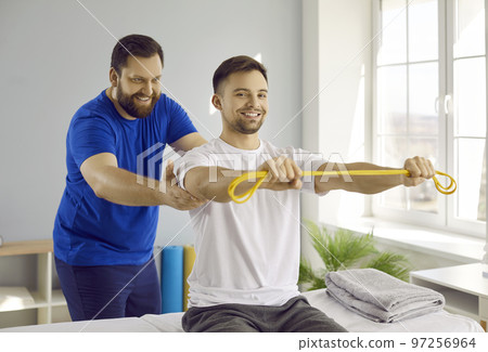 Patient do exercise with physiotherapist for trauma recovery 97256964