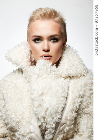 young short blond hair woman in white fur. beautiful bald girl young short blond hair woman in white fur. beautiful bald girl 97257959