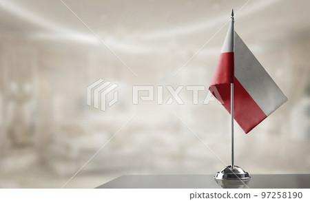A small Poland flag on an abstract blurry background A small Poland flag on an abstract blurry background 97258190