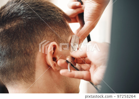 Barber shaving bearded man with retro knife Barber shaving bearded man with retro knife 97258264
