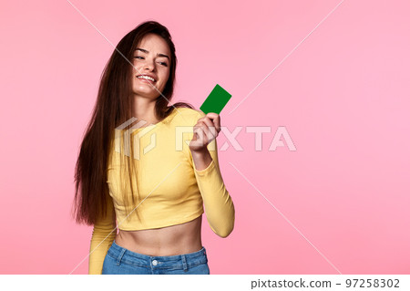 woman in yellow clothes holding plastic credit card woman in yellow clothes holding plastic credit card 97258302
