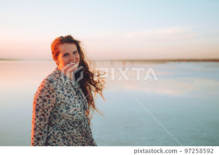 Portrait happy laughing woman in pink dress Portrait happy laughing woman in pink dress 97258592