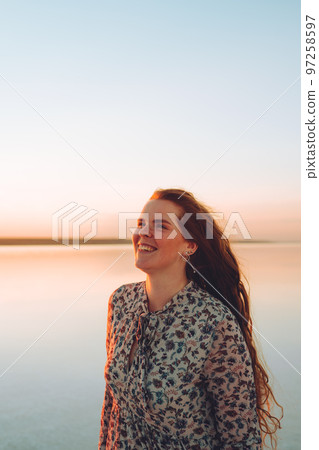 Portrait happy laughing woman in pink dress 97258597