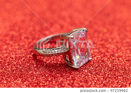 Will you marry me. Wedding ring on red glitter background. Engagement marriage proposal wedding concept. St. Valentine's Day postcard. Banner on valentines day. Copy space Will you marry me. Wedding ring on red glitter background. Engagement marriage proposal wedding concept. St. Valentine's Day postcard. Banner on valentines day. Copy space 97259462