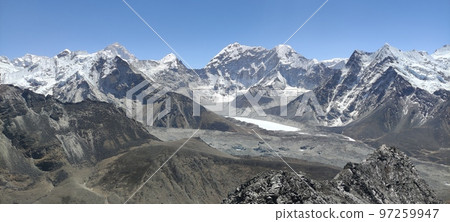 Beautiful view of high snow capped mountain peaks under blue sky in Mount Everest at nepal Beautiful view of high snow capped mountain peaks under blue sky in Mount Everest at nepal 97259947