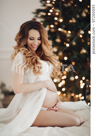 Charming pregnant woman poses for the camera in 97260895