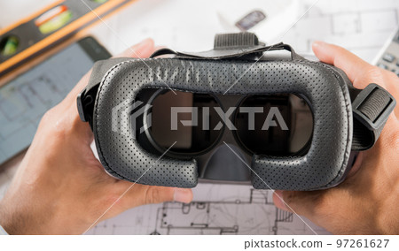 Architectural building design hold back 3D VR glasses and construction plans with blueprints paper project plans, designing man edit building or architecture, technology industry, Architect workplace Architectural building design hold back 3D VR glasses and construction plans with blueprints paper project plans, designing man edit building or architecture, technology industry, Architect workplace 97261627