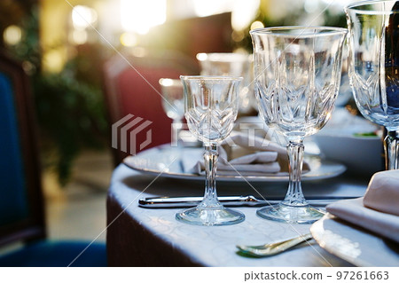 empty wine glasses on the table.table setting for a festive dinner. solar glare. empty wine glasses on the table.table setting for a festive dinner. solar glare. 97261663