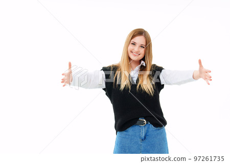 a blonde in a black vest extends his open arms forward on a white background a blonde in a black vest extends his open arms forward on a white background 97261735