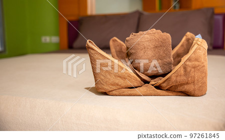 Yellow towel on bed decoration in bedroom interior, Freshly laundered fluffy towels, Towel in hotel room, Beautifully folded toiletries Yellow towel on bed decoration in bedroom interior, Freshly laundered fluffy towels, Towel in hotel room, Beautifully folded toiletries 97261845