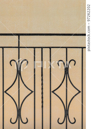 Iron black architectural geometric metal vertical element, decorative fence steel design lattic on beige sand wall background 97262202