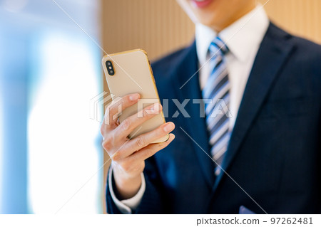 Hands of a man touching his smartphone, photography cooperation "LINK FOREST" 97262481