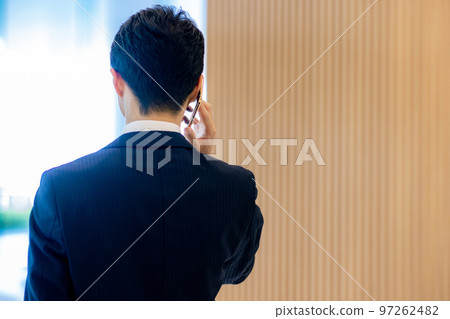 A businessman making a phone call from behind Photographed by "LINK FOREST" 97262482