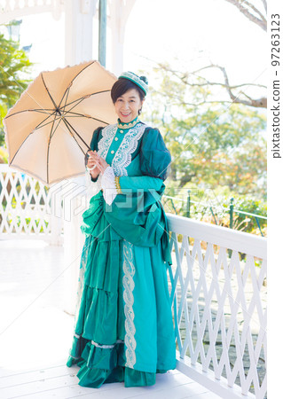 A middle-aged woman wearing a retro costume and enjoying a girls' trip 97263123