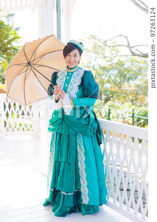 A middle-aged woman wearing a retro costume and enjoying a girls' trip 97263124