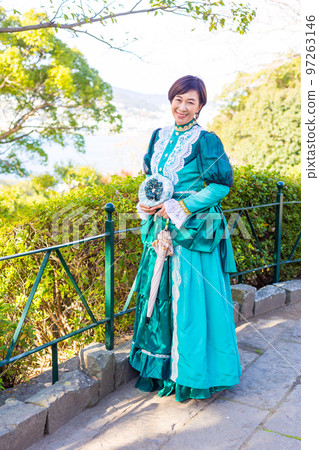 A middle-aged woman wearing a retro costume and enjoying a girls' trip 97263146