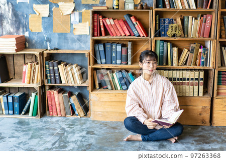 年輕女子在別緻的房間裡放鬆和閱讀 97263368