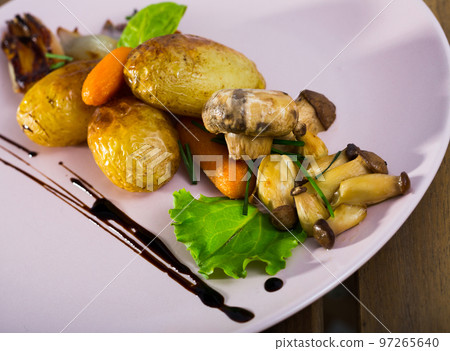 Baked mushrooms with garlic and potatoes, served with caramelized onion shalot 97265640