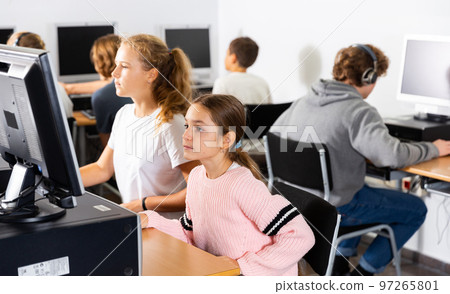 Portrait of two schoolgirls at the computer 97265801