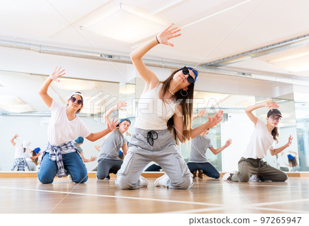 Teens hip hop dancers posing on knees Teens hip hop dancers posing on knees 97265947