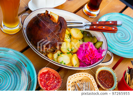 German pork hock with sliced potato and marinaded foods 97265955
