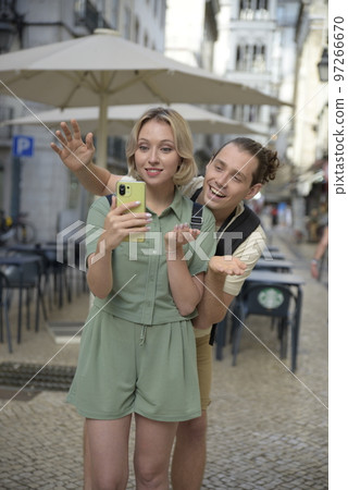 Joyful tourist couple making video call Joyful tourist couple making video call 97266670