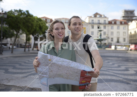 Happy tourist couple looking forward Happy tourist couple looking forward 97266771