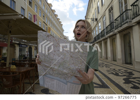 Surprised woman holding map Surprised woman holding map 97266775