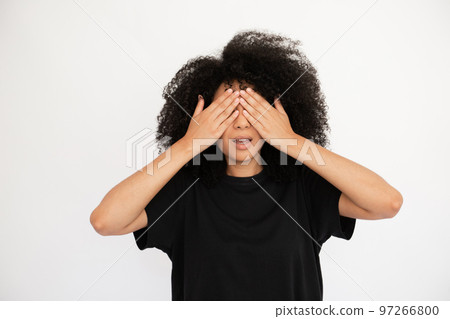 Amazed young woman closing eyes waiting for surprise Amazed young woman closing eyes waiting for surprise 97266800