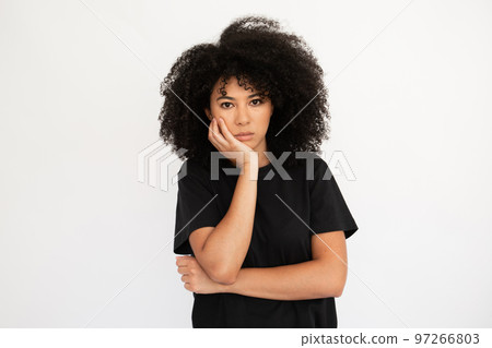 Displeased young woman holding hand on her cheek 97266803