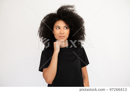 Pensive young woman looking away holding hand on her chin Pensive young woman looking away holding hand on her chin 97266813