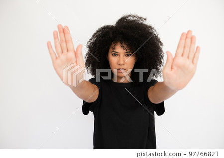 Serious young woman showing stop signs Serious young woman showing stop signs 97266821