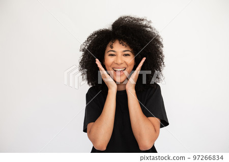 Amazed young woman throwing hands up Amazed young woman throwing hands up 97266834