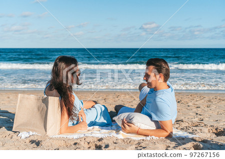 Young couple on the beach lying on towel and enjoy time together 97267156
